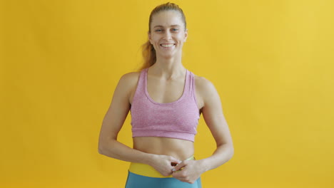 woman measuring waist for fitness