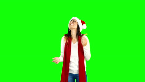 Woman-in-santa-hat-and-warm-clothing-looking-upwards