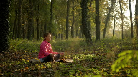 woman meditating in a peaceful forest