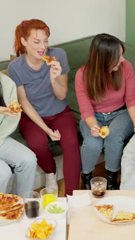 friends eating pizza and talking at home