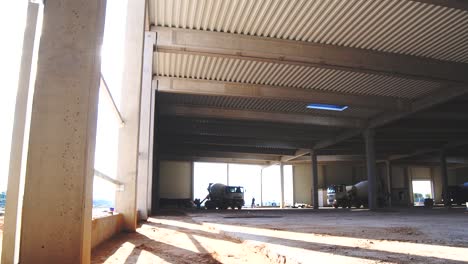 construction of a hall with concrete mixers in the background and sunlight streaming through a window