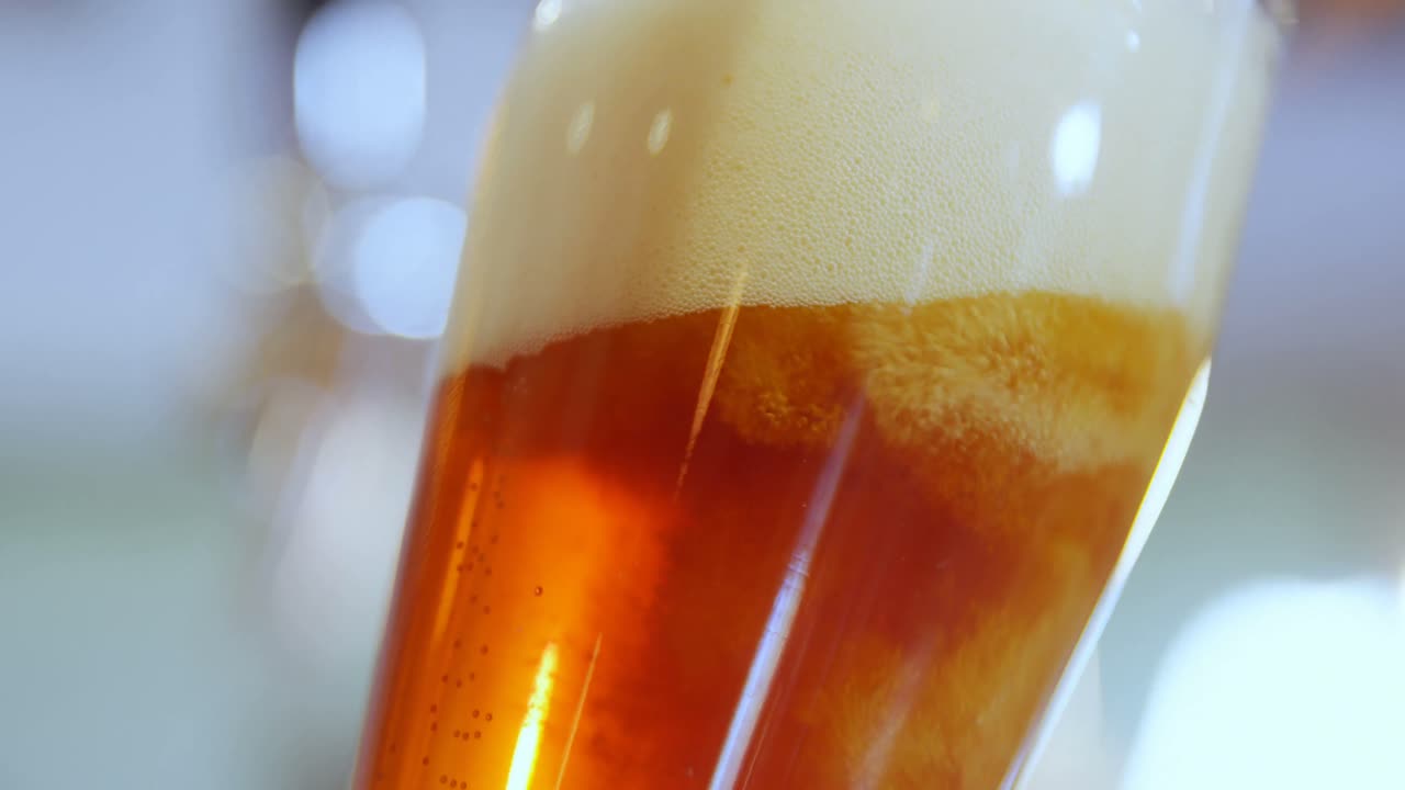 Person drinking beer from straw 4k