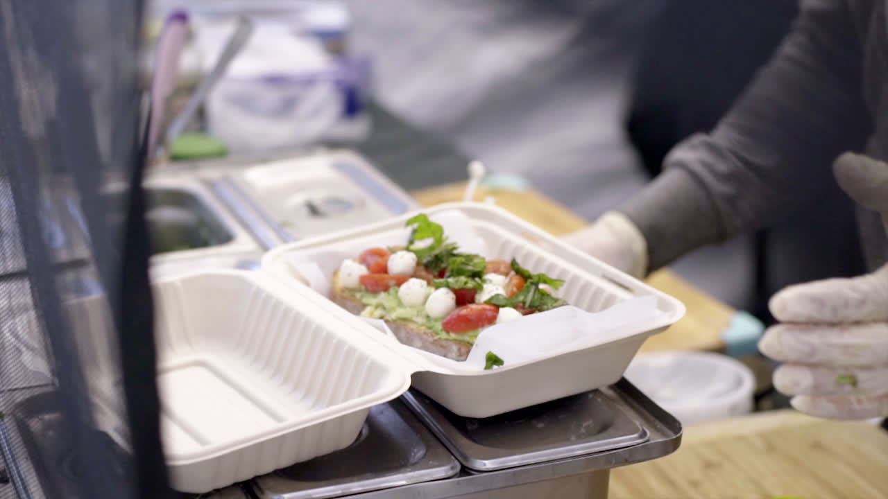 Preparing Healthy Avocado Caprese Toast for Takeout