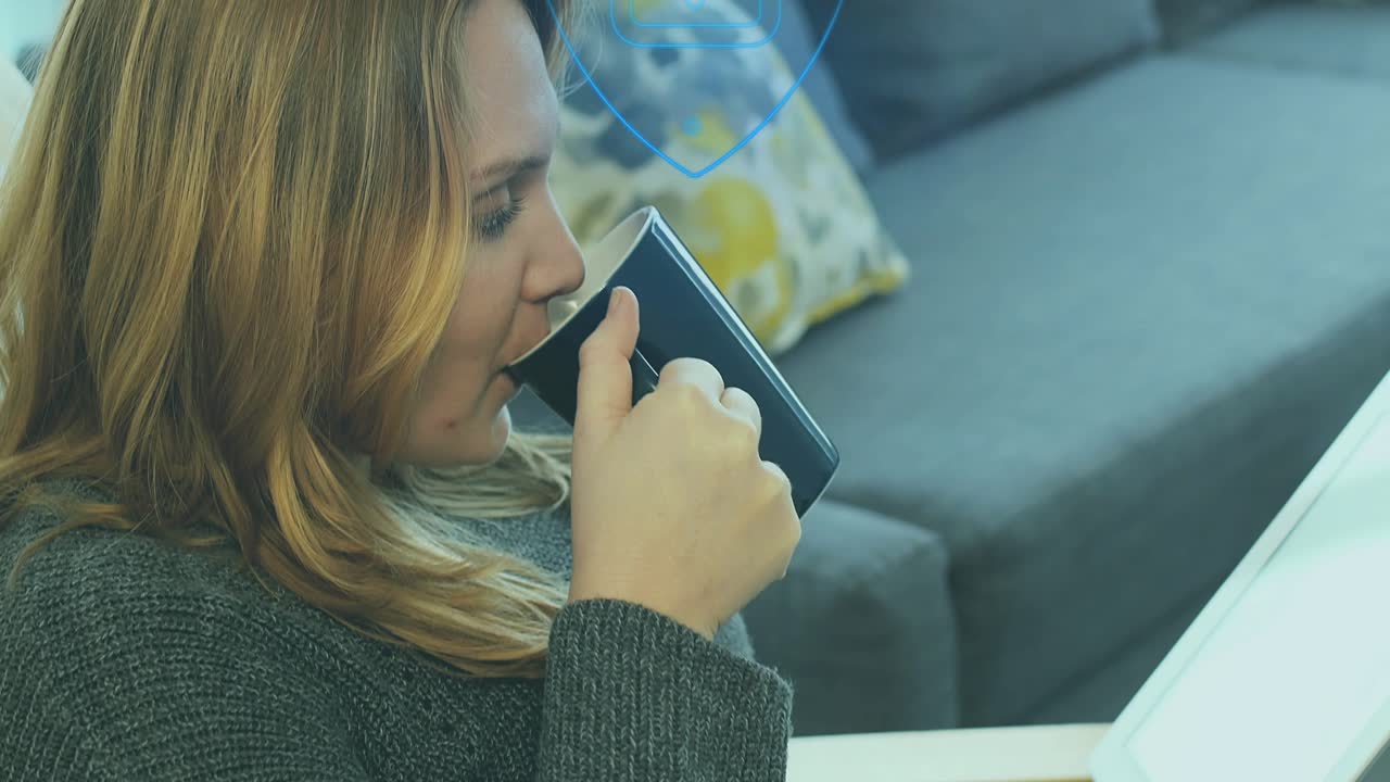 Woman settling into armchair as blue particles forming into shield unlocking security documents
