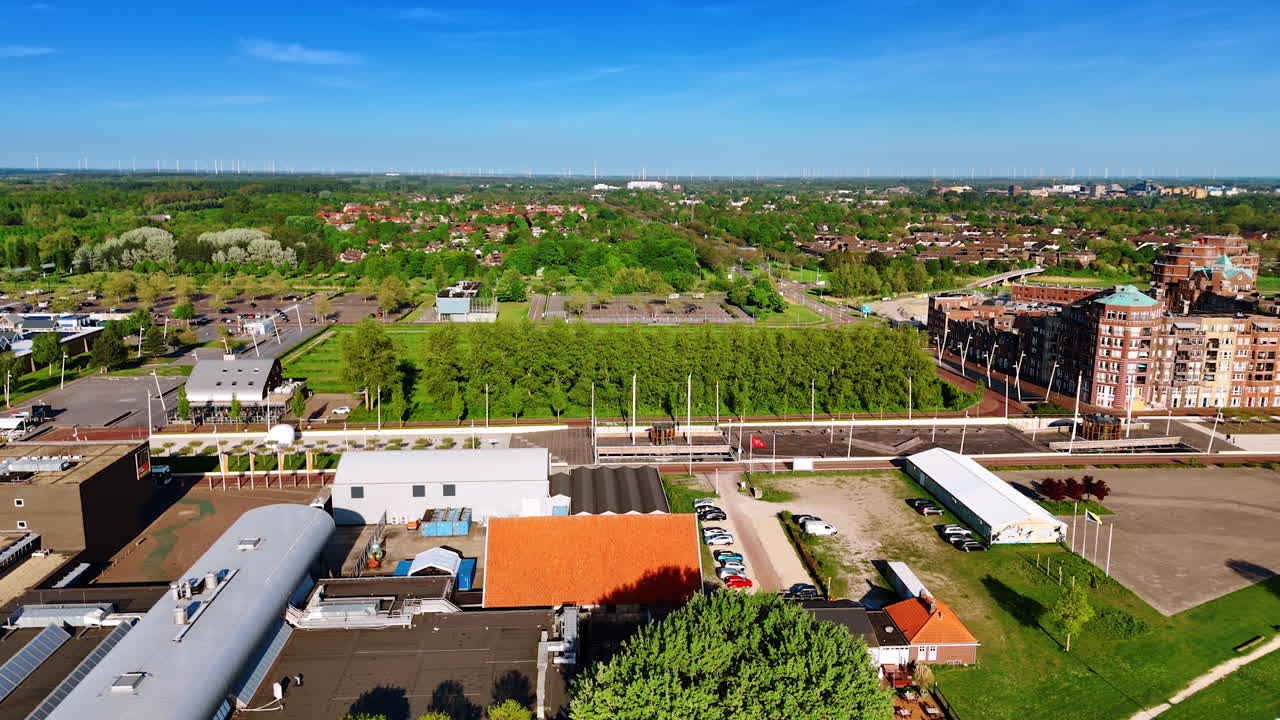 Approaching the waterfront of a beautiful Lelystad, the Netherlands. Sunny view of the city full of lush greenery. Top view.