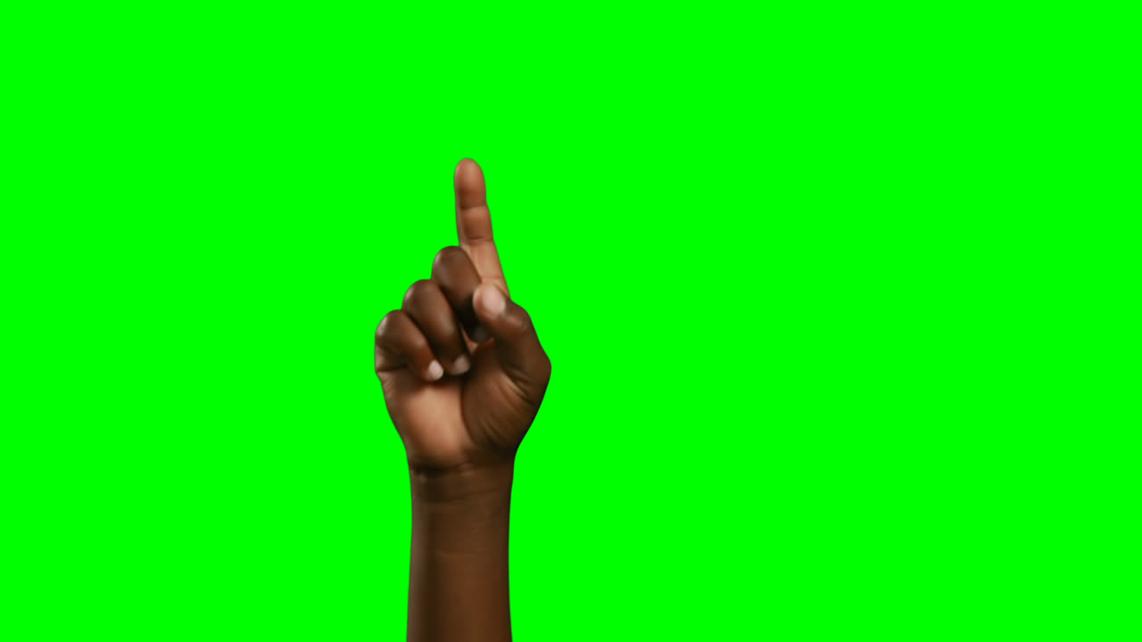 Person making hand gesture against green screen background