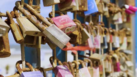 love locks on a rusty fence