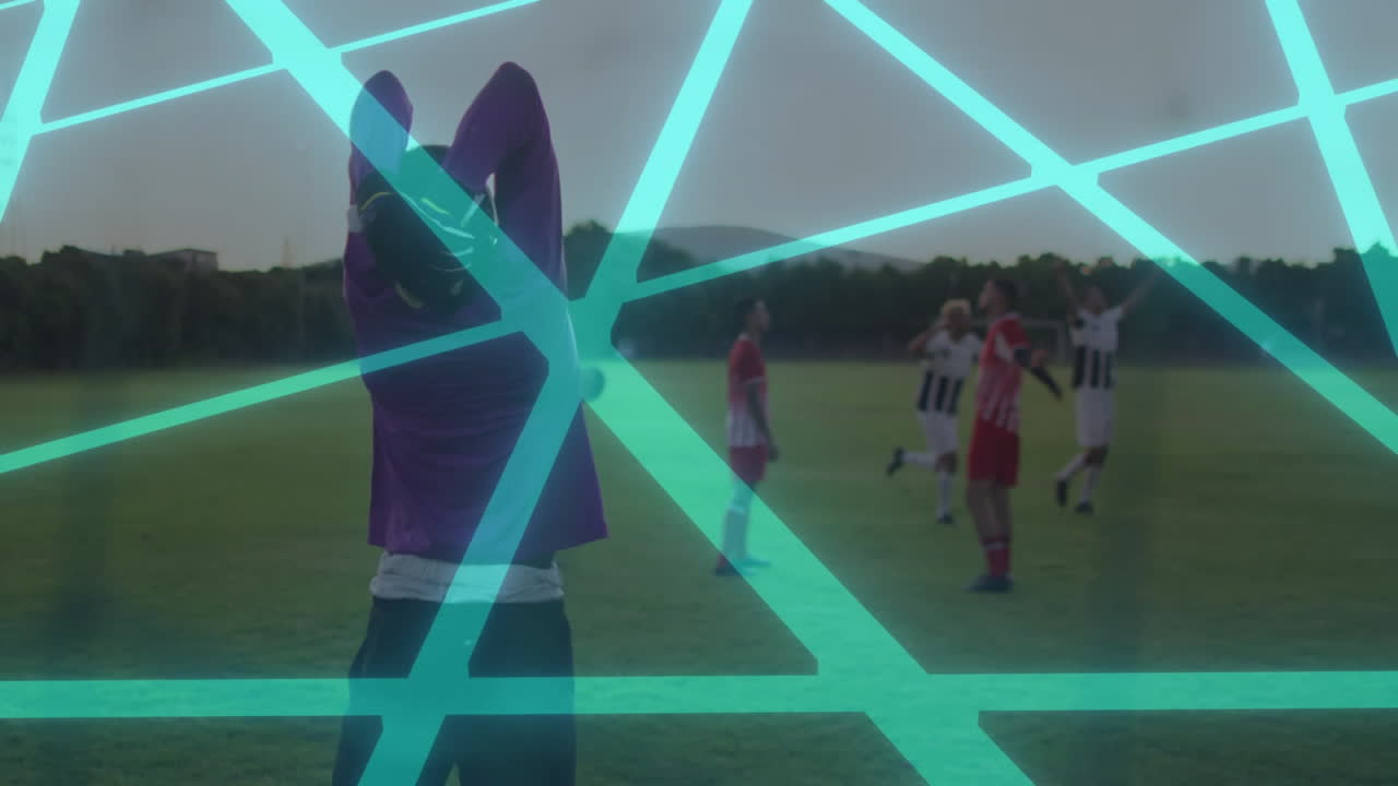 Soccer players celebrating on field with digital network lines overlay animation