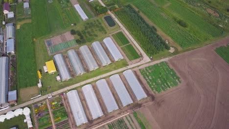 aerial view of a large farm with greenhouses and open-field crops