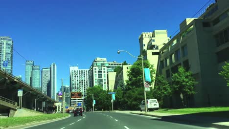 Travelling-east-on-Lakeshore-in-Toronto,-coming-to-a-near-stop-as-traffic-thickens-near-Gardiner-Expressway