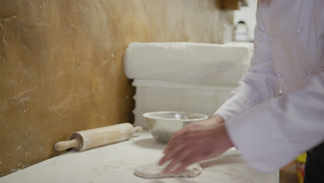 caucasian man making a pizza dough