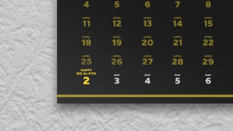 primer plano de una hermosa página de calendario de pared negra con un horario de los días de ayuno de ramadán 2022 y la cámara se mueve a la fecha de eid al-fitr marcada en amarillo