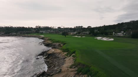 push in aerial drone shot of the 18th hole at pebble beach golf links in california