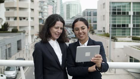 businesswomen having video chat via tablet pc