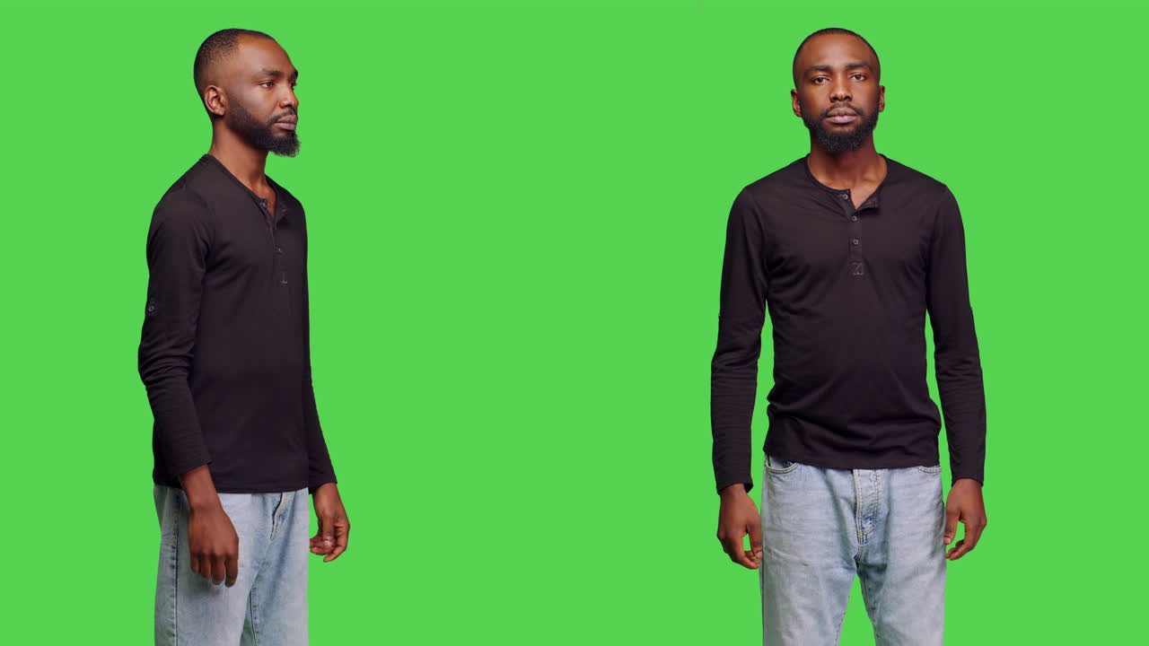 Man in black shirt making hand gestures on green screen