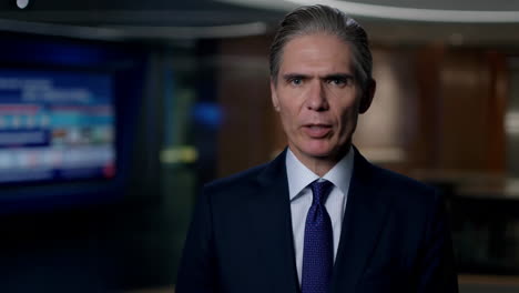man in a suit speaking in a professional setting