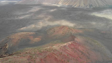 aerial view of a red volcanic landscape on a cloudy day