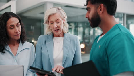a doctor, nurse, and patient discussing something in a hospital