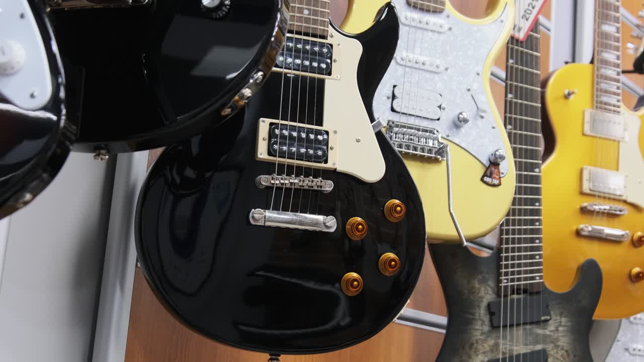 Lot of Multicolored Electric Guitars Hanging in a Music Store, Guitar Shop