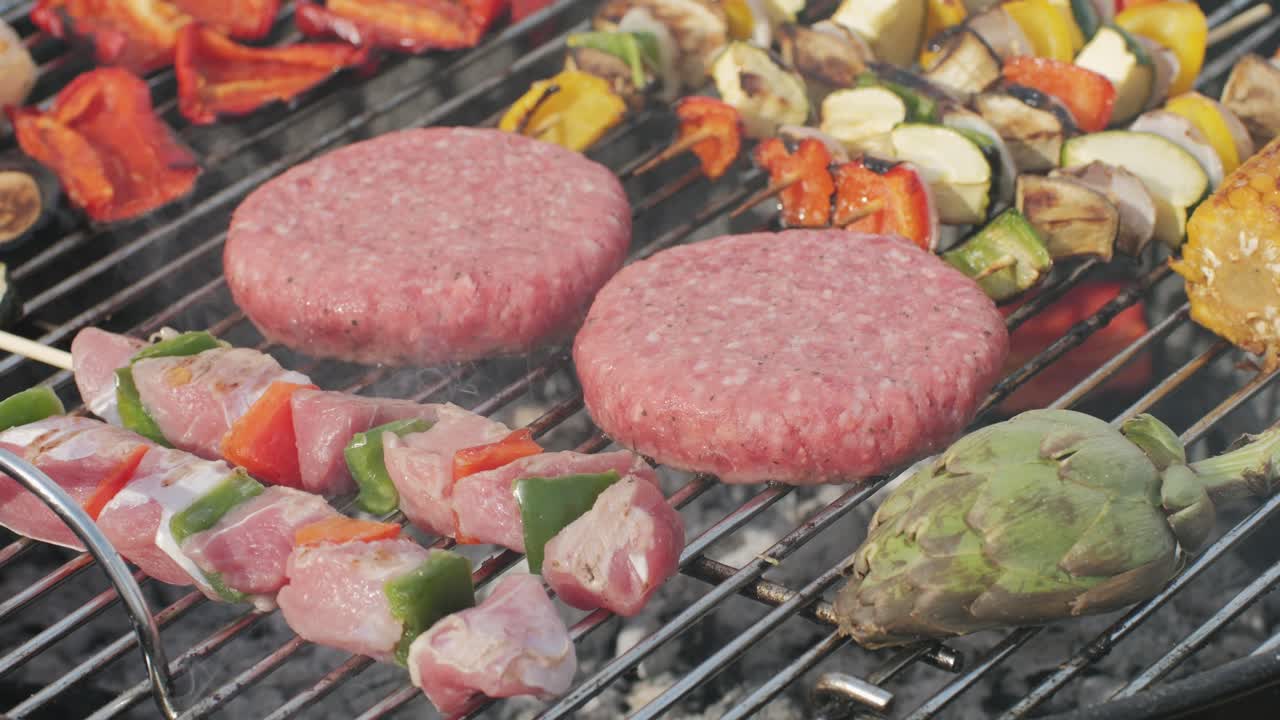 Traditional spanish barbeque, big sausage chorizo botifarra, pork and beef ribs on grill with fire, american style cooking, chef grilling meat fat food, steaks and sausages on bbq. High quality 4k footage