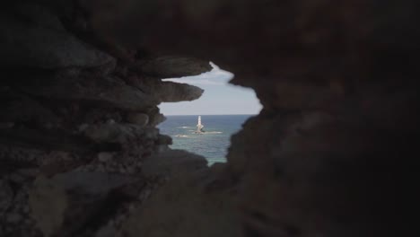 Closeup of Tourlitis Lighthouse in Chora of Andros Among Medieval Ruins, Greece