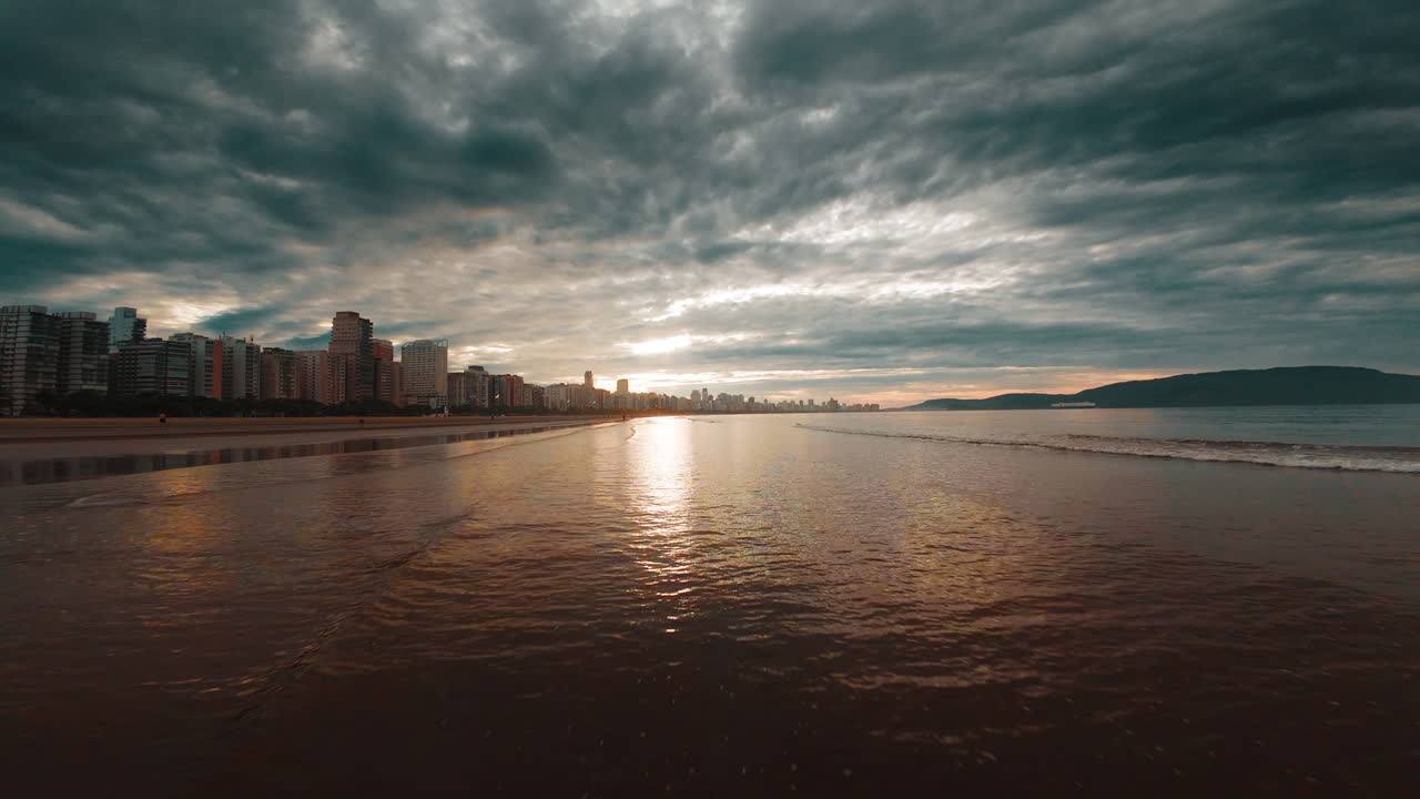 Dramatic Sunset over Coastal City Beach