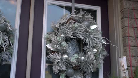 white christmas wreath at entrance of house with double door