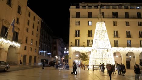 festive evening in alicante with a large illuminated christmas tree and holiday lights