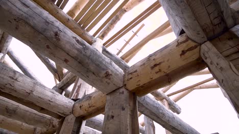 log cabin construction under roof framing