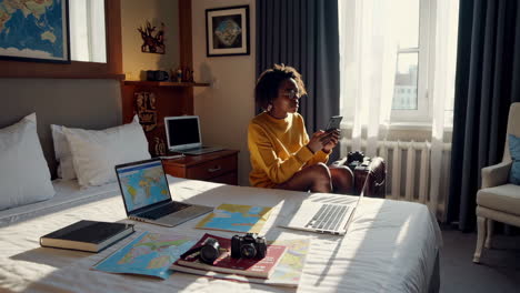 Woman Planning Trip in Hotel Room