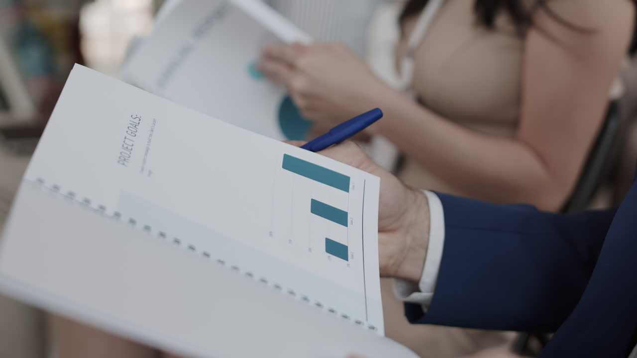Unrecognizable Business Person Reading Annual Report