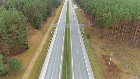 speed monitoring device over highway road in woodland area, aerial view