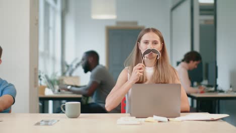 young woman having fun at coworking office. joyful lady making male.