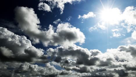 Timelapse-of-clouds-in-a-blue-sky-with-the-sun-in-and-out