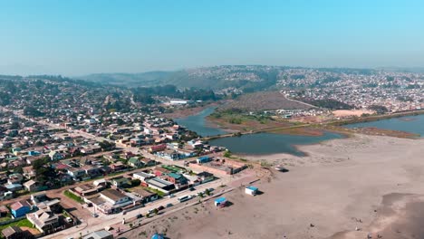 Aerial-view-of-estuary-next-to-the-beach-during-sunny-day-in-Cartagena,-San-Antonio-province,-Chile