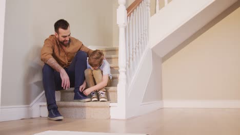Caucasian-man-and-his-son-sitting-on-the-stairs