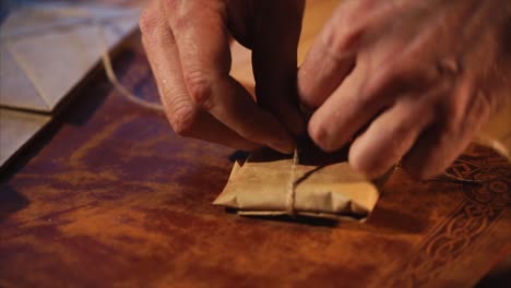 hands wrapping a package with string
