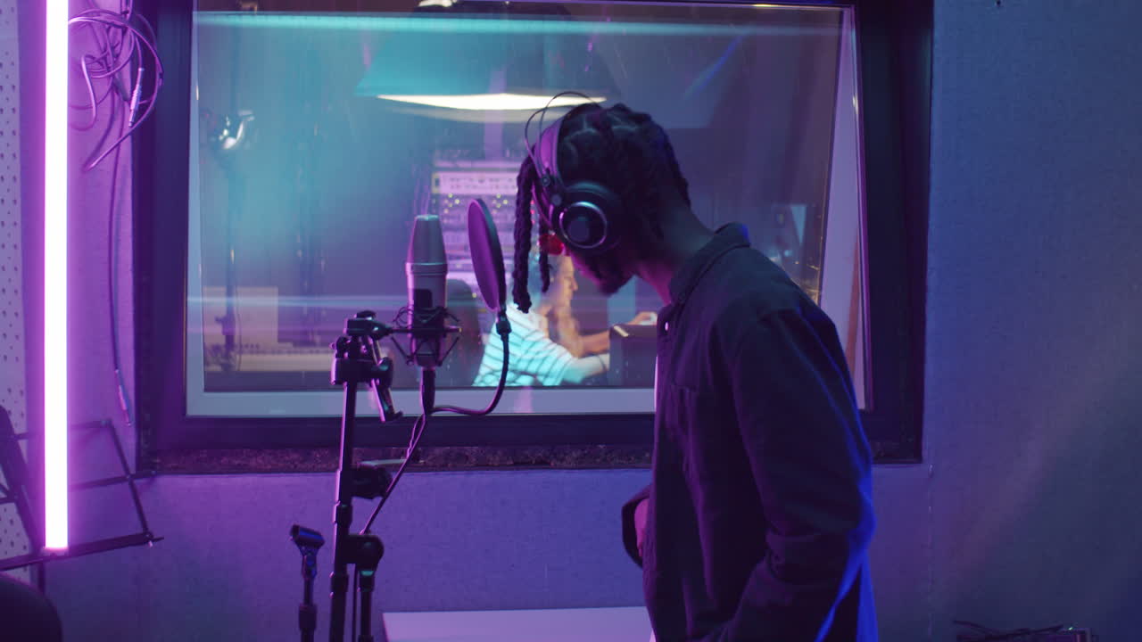 African American Man Recording Song in Studio