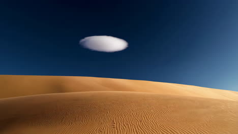 circular cloud formation over desert sand dunes