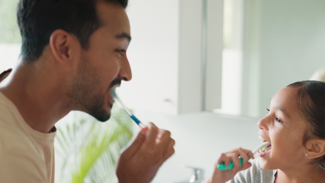 Father brushing his teeth with his child