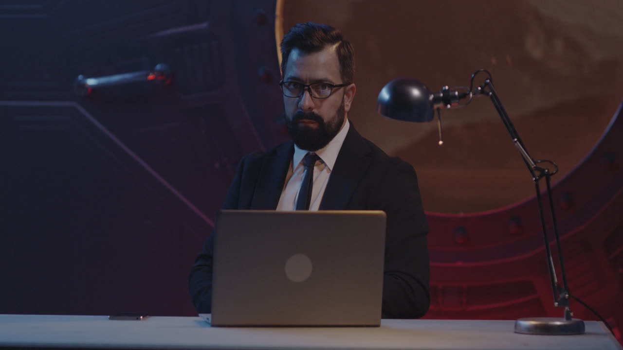 Businessman Working on Laptop in Futuristic Office