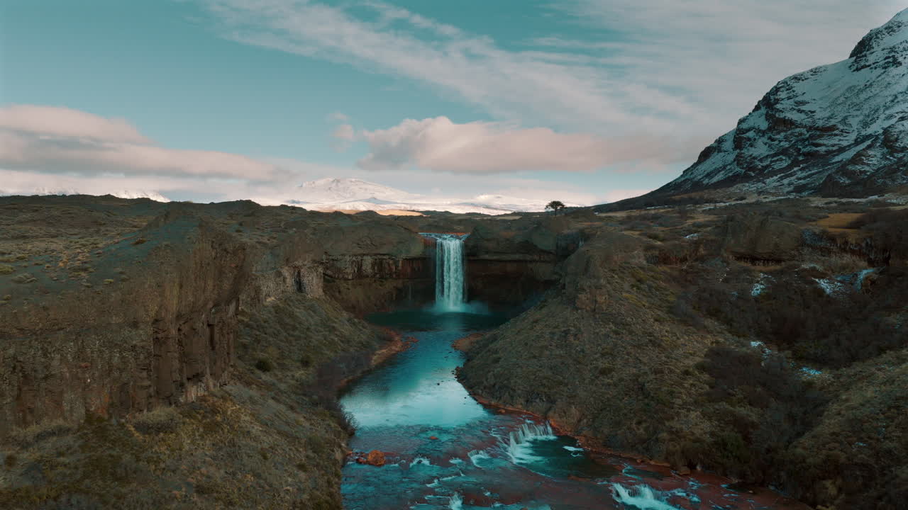 Surreal aerial view revealing the stunning Salto del Agrio waterfall surrounded by dramatic volcanic landscape in Patagonia, Argentina