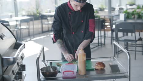 chef preparing burger on grill