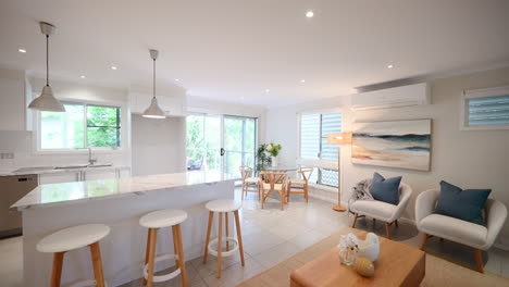 Modern Contemporary Kitchen and Living Room Fully Staged To Balcony Outdoor Picnic Lounge Area in Tropical Setting