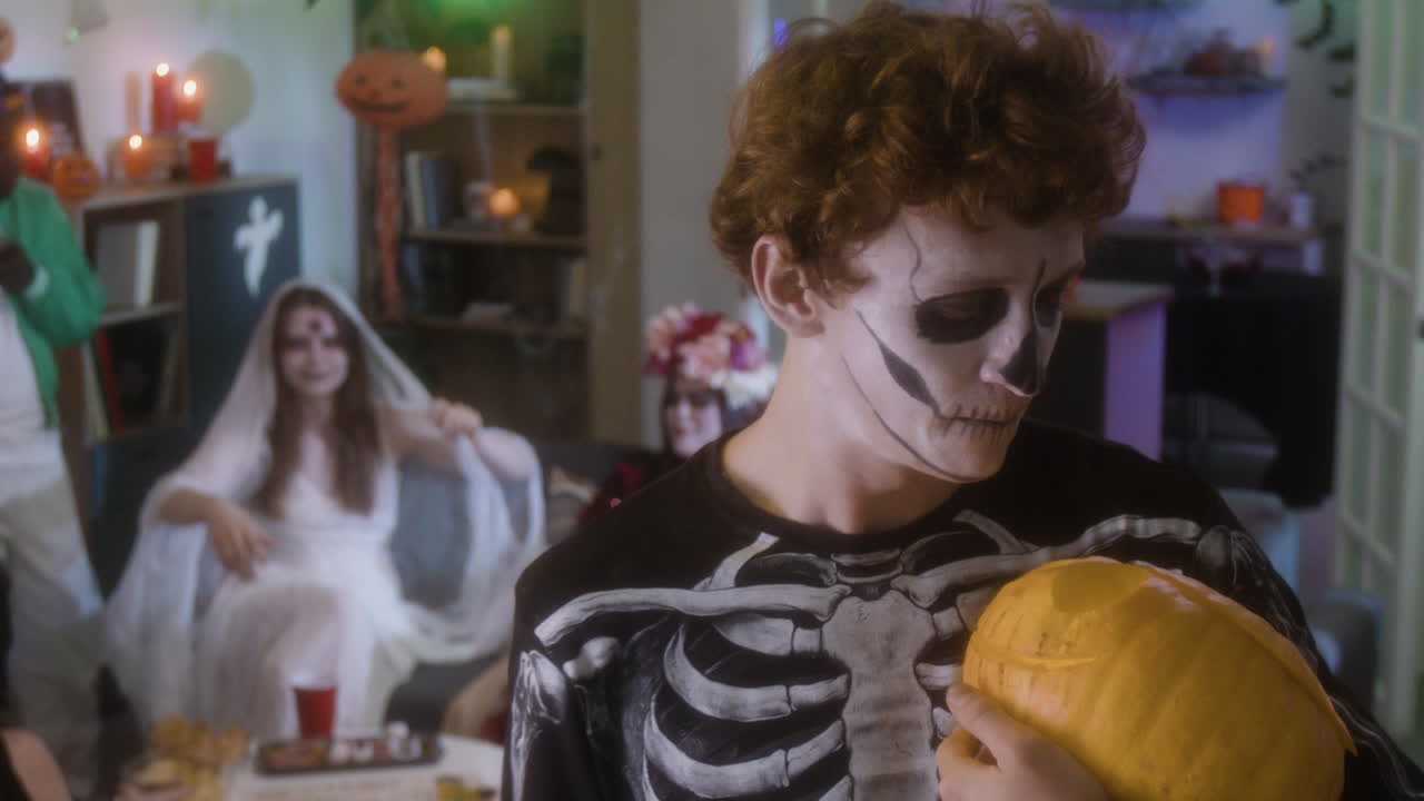 Halloween Party with Costumes and Pumpkins