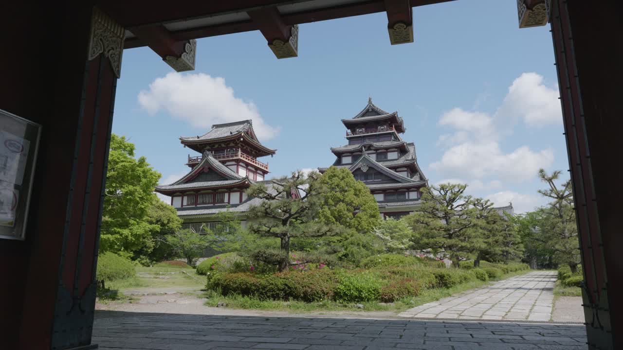 Traditional japanese castle and entry gate on a sunny day at Fushimi Castle, Kyoto, Japan