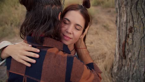 Close-up-shooting:-A-brunette-boy-and-a-brunette-girl-are-swinging-on-a-swing.-Couple-in-love-hugging.-Rest-in-the-country-house