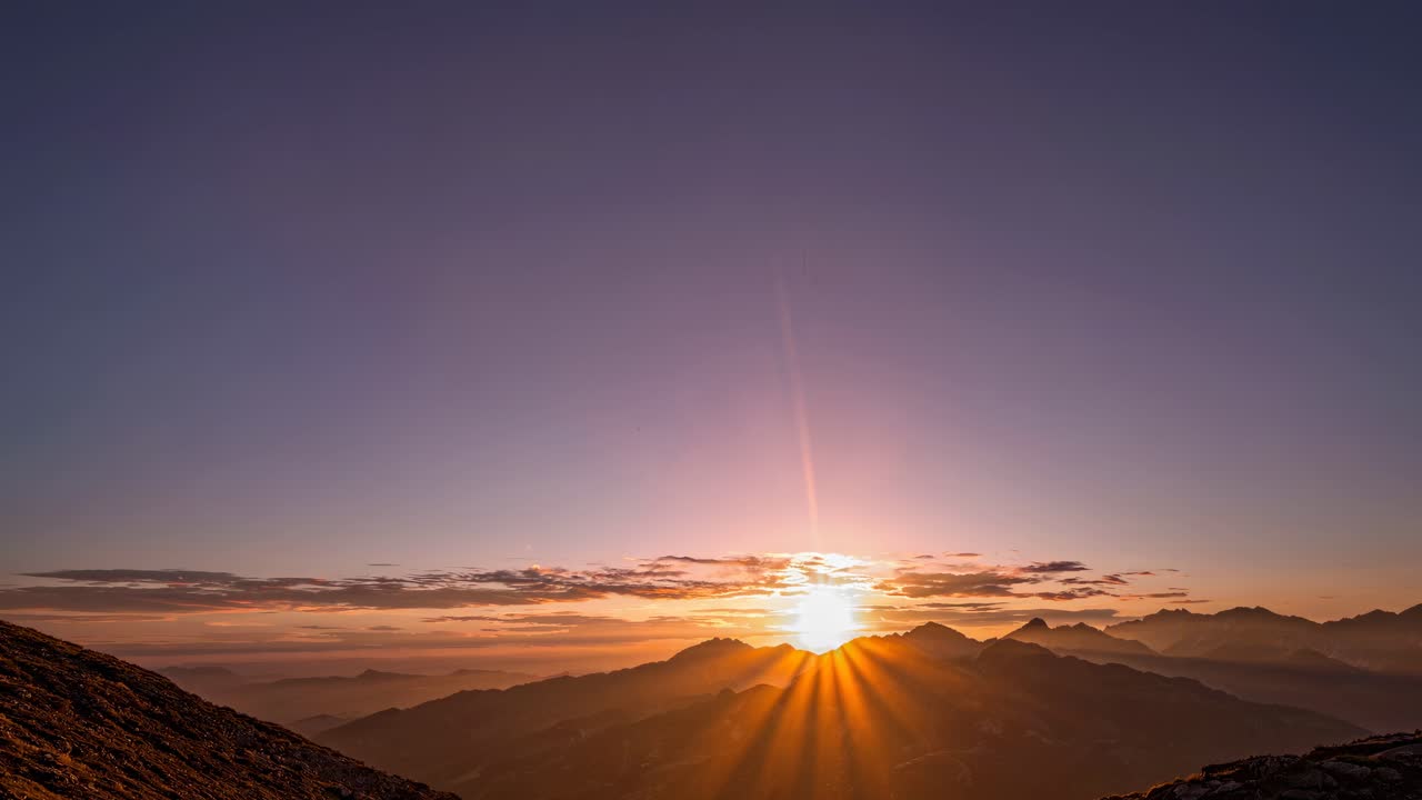 A serene video capturing a breathtaking sunrise over mountain peaks, emphasizing tranquility