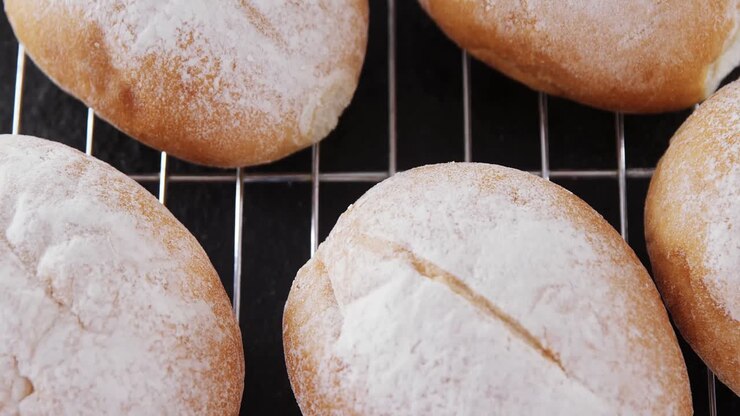 Dough balls with icing sugar on baking tray 4k