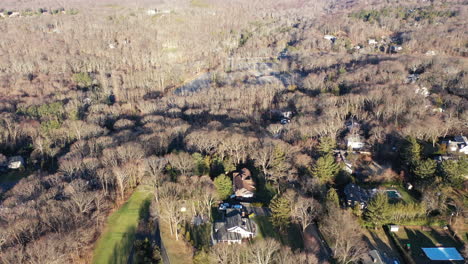 an-aerial-view-over-the-edge-of-a-pristine-golf-course,-on-a-sunny-day